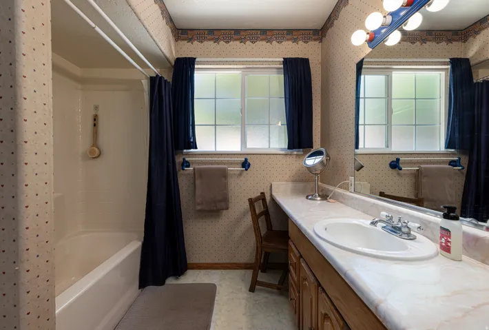 Spacious bathroom with tub and shower and extra long vanity sink