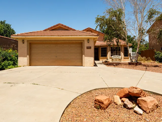 Front exterior featuring, a tile roof, and a concrete driveway