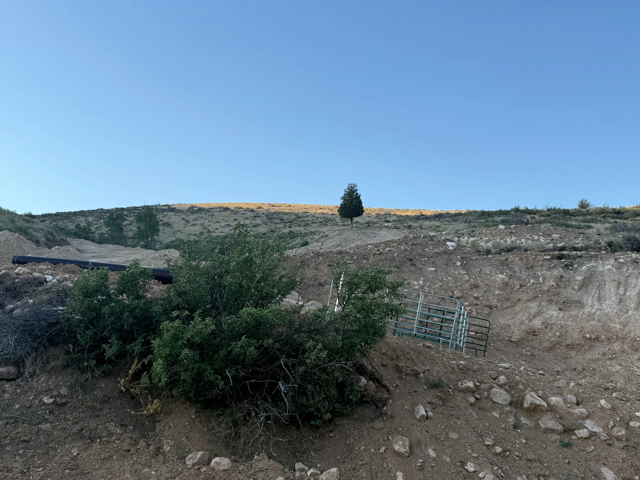 Expansive undeveloped land featuring natural terrain and sparse vegetation