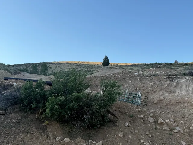 Expansive undeveloped land featuring natural terrain and sparse vegetation