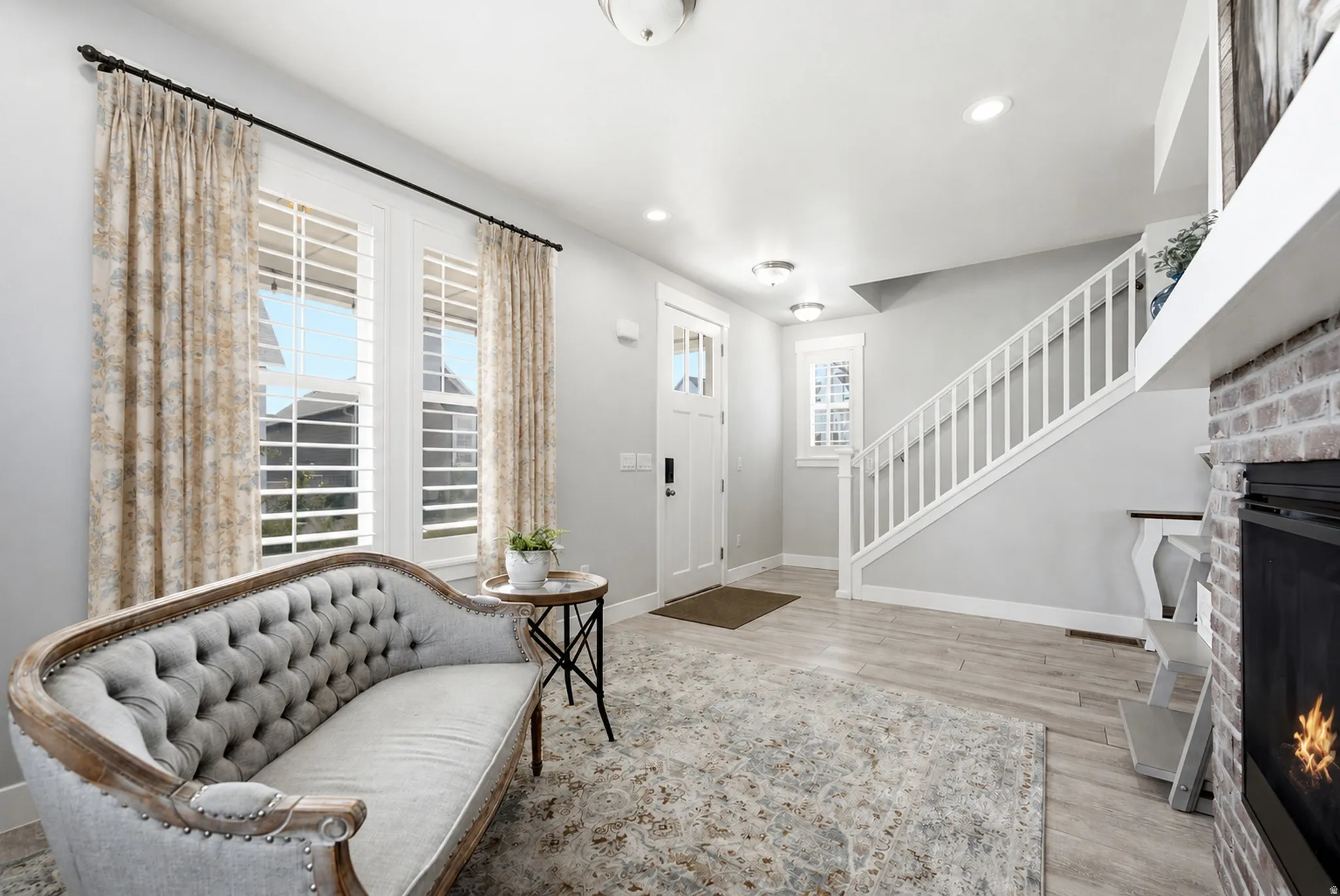 Bright living space featuring light wood-finish flooring