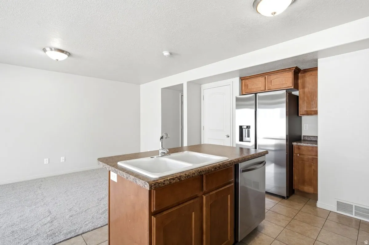 Kitchen island with double basin sink and stainless steel faucet
