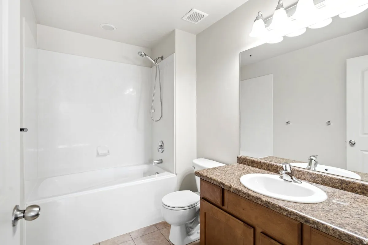 Bathroom featuring a white bathtub and shower combination with a bright white surround