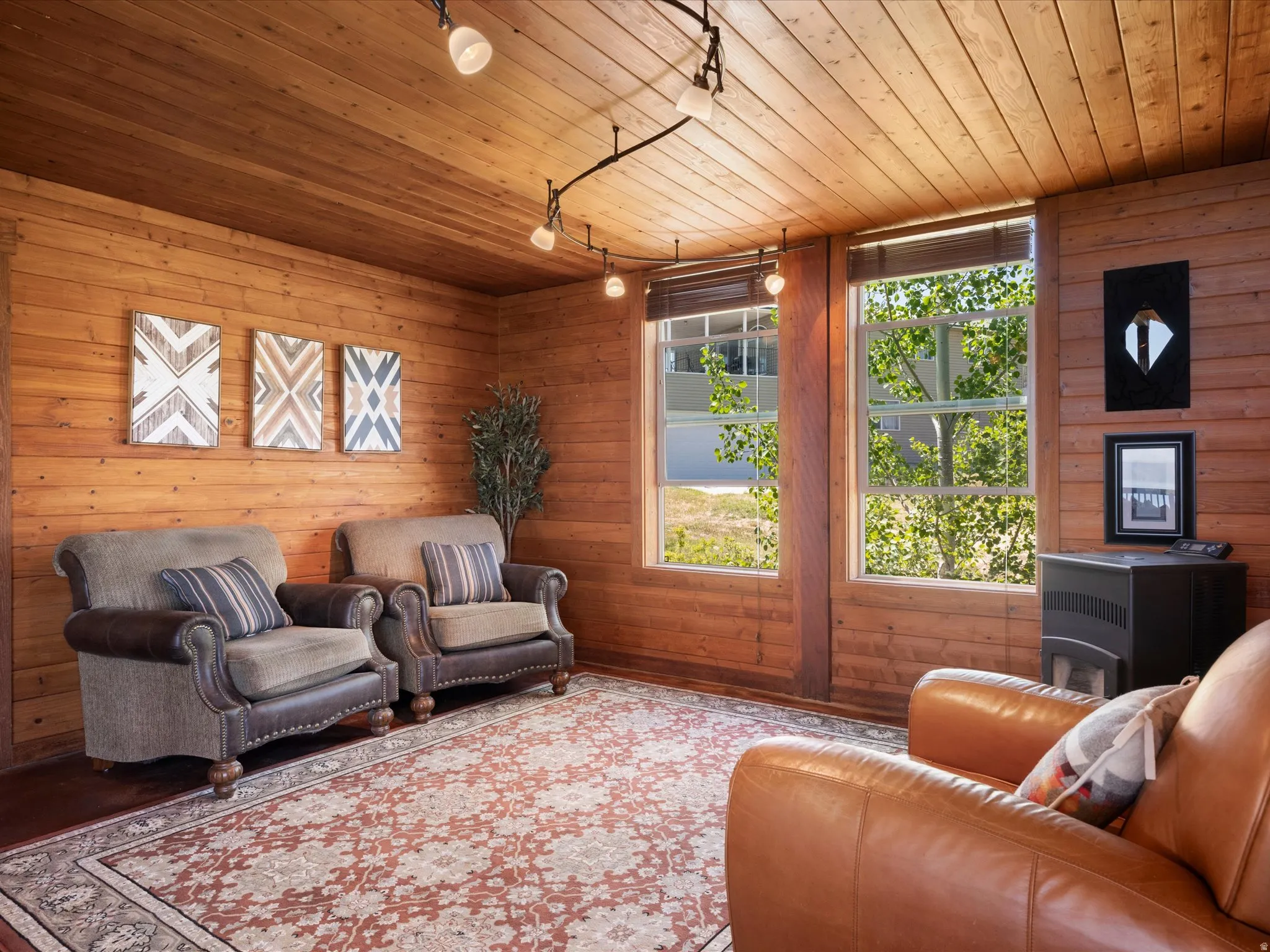 Room featuring extensive wood-paneled walls and a matching wood-paneled ceiling