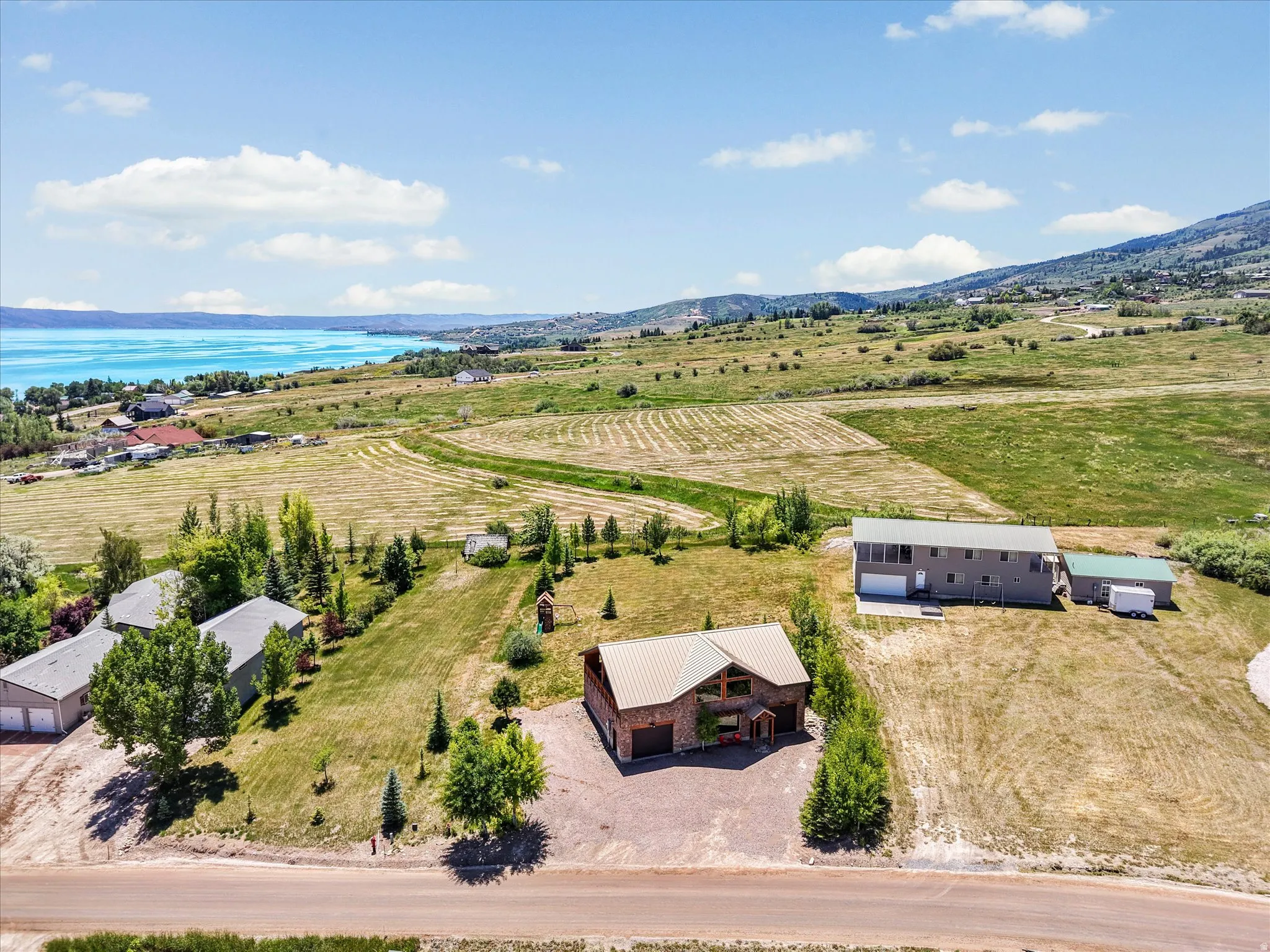 Expansive property featuring three distinct structures and a large open field