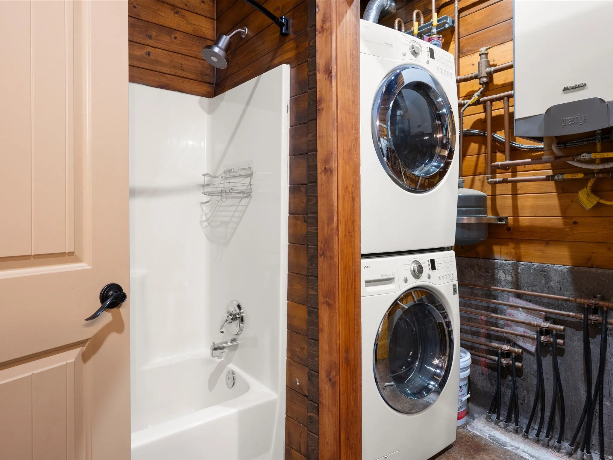 Compact laundry area featuring stacked washer and dryer units