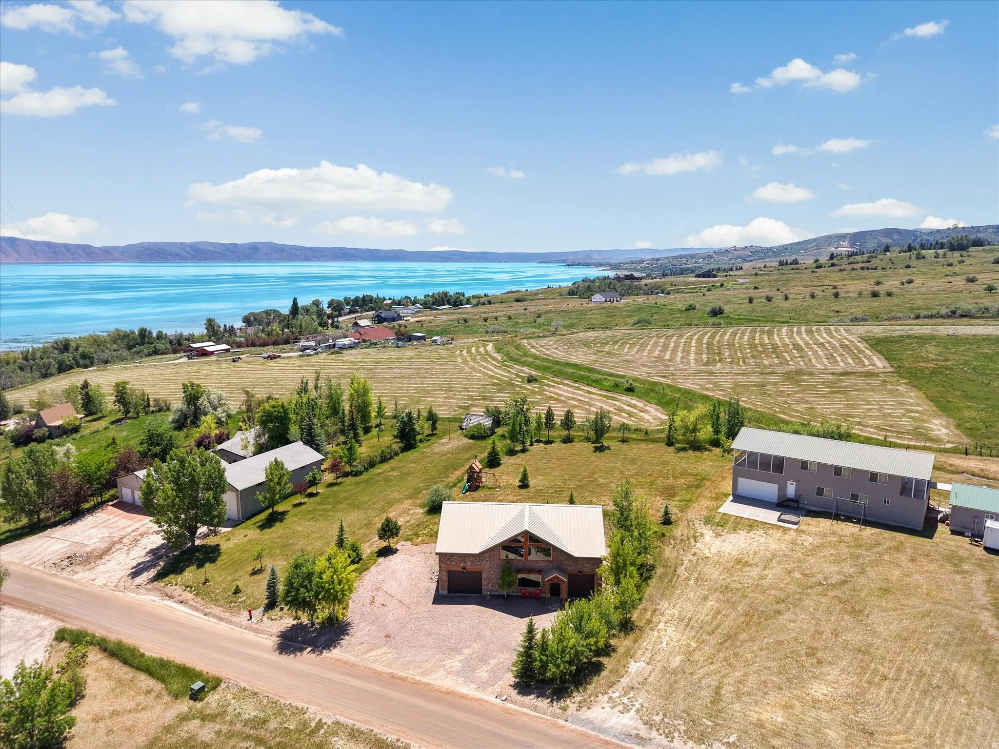 Aerial perspective showcasing a sprawling property with multiple structures and expansive grounds