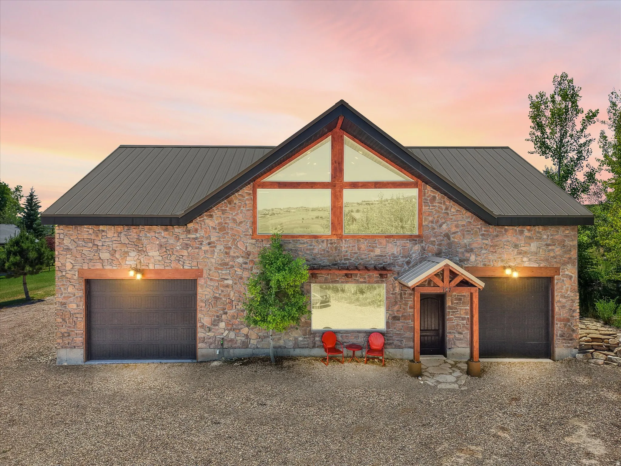 Stone facade structure with a dark metal roof