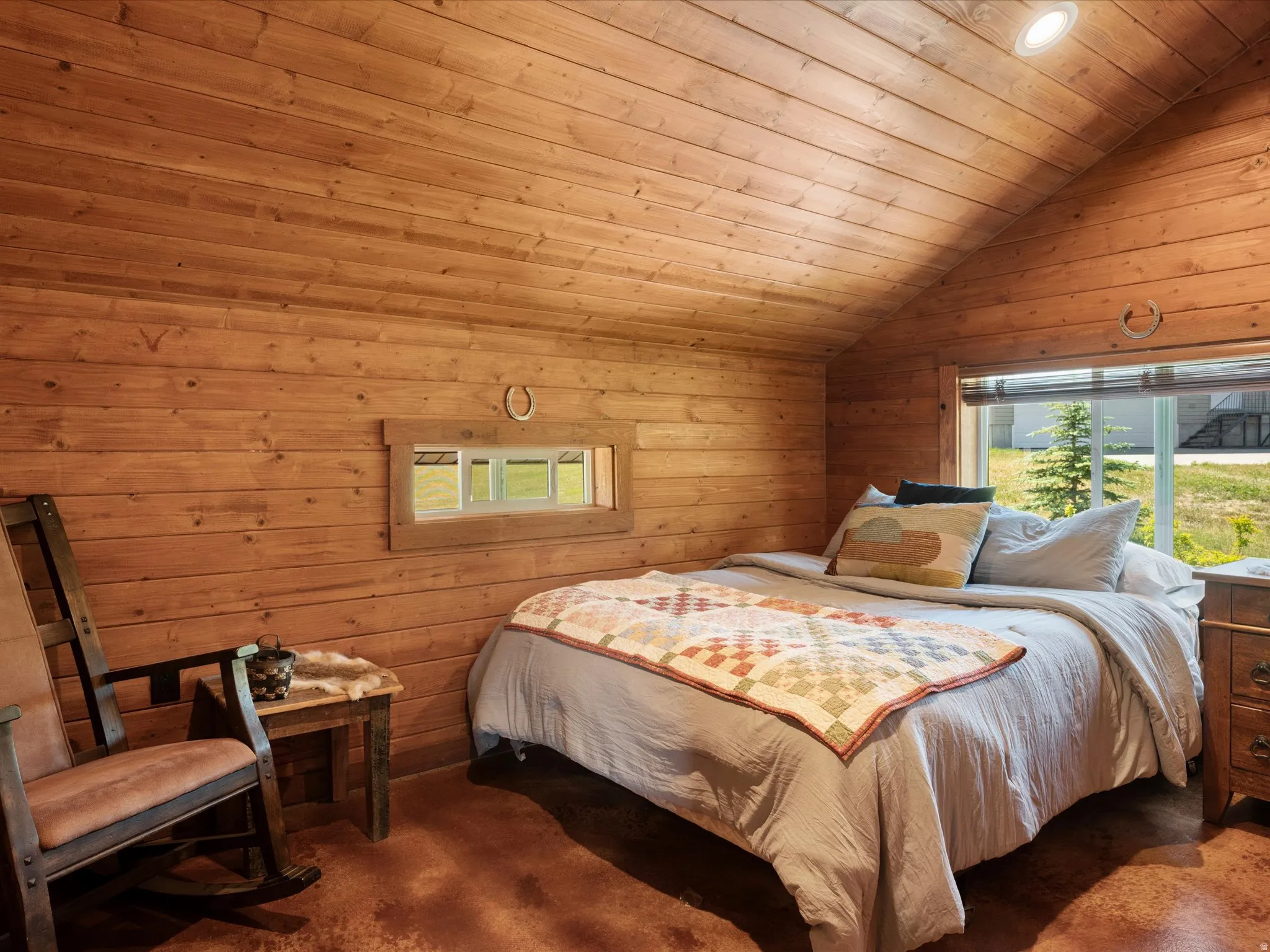 Pine wood-paneled walls and ceiling with recessed lighting