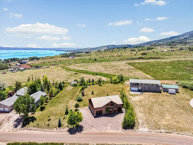 Expansive property featuring three distinct structures and a large open field