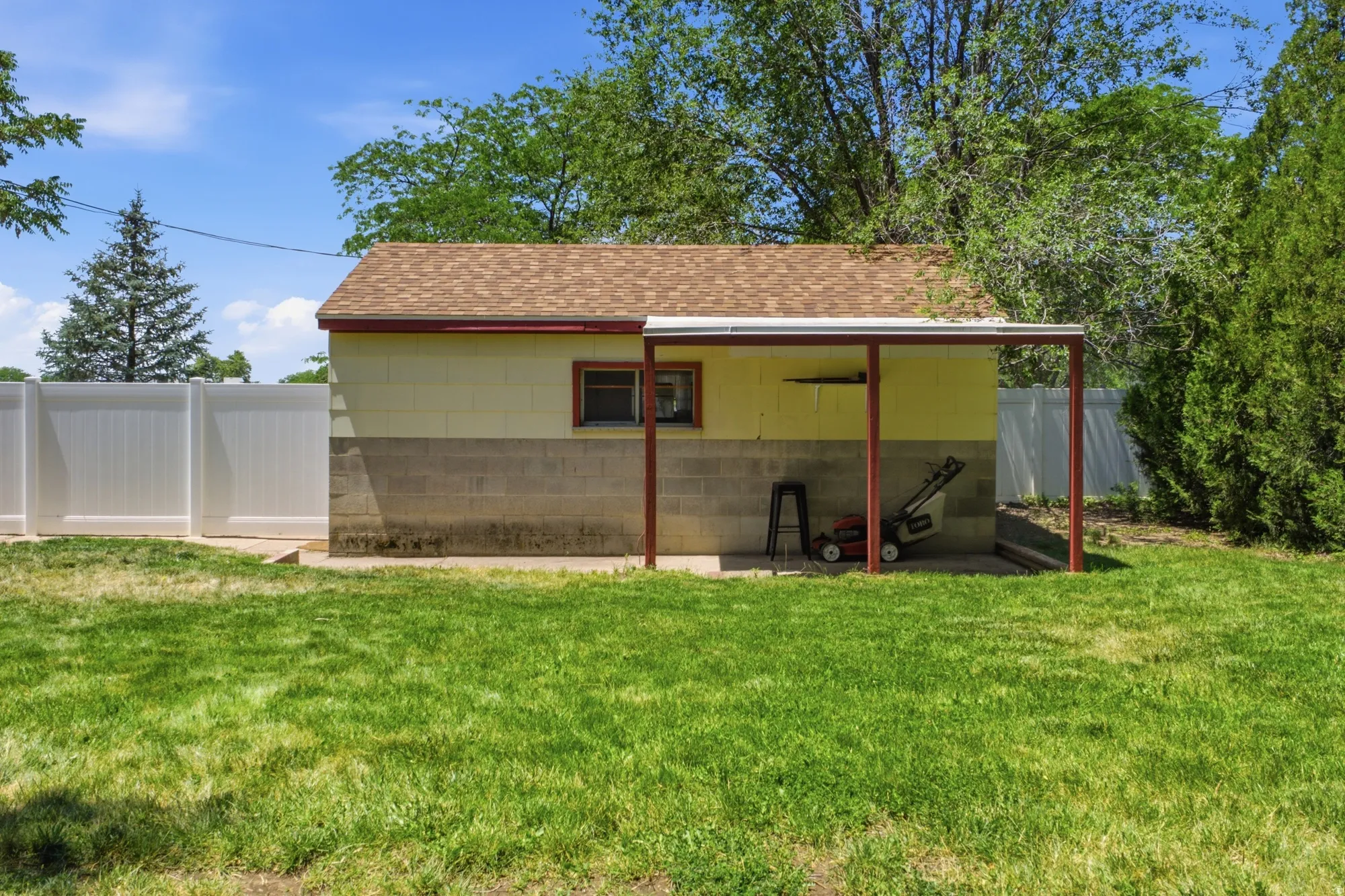 Detached garage with covered side area, perfect for storage, tools, or outdoor projects.