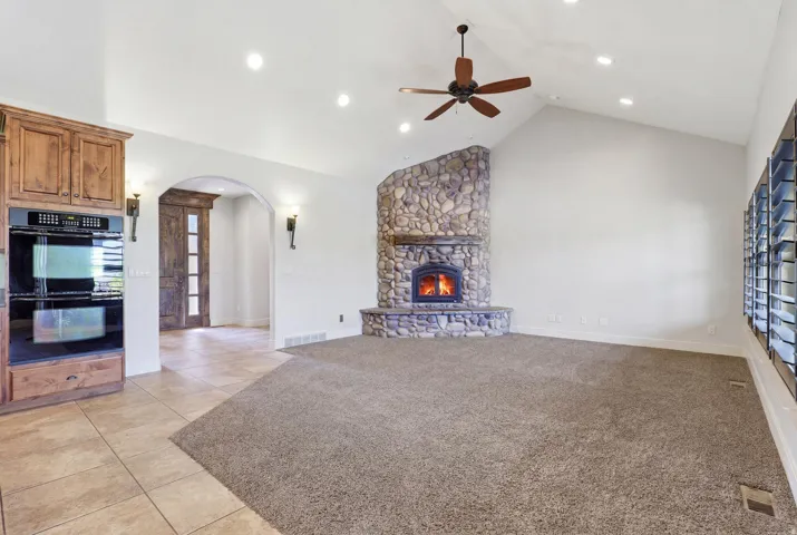 Vaulted ceilings with recessed lighting and a ceiling fan