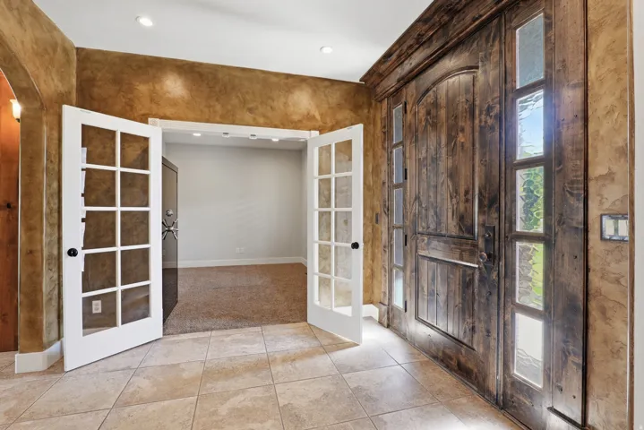 Rustic wood-finish double entry doors with sidelight windows