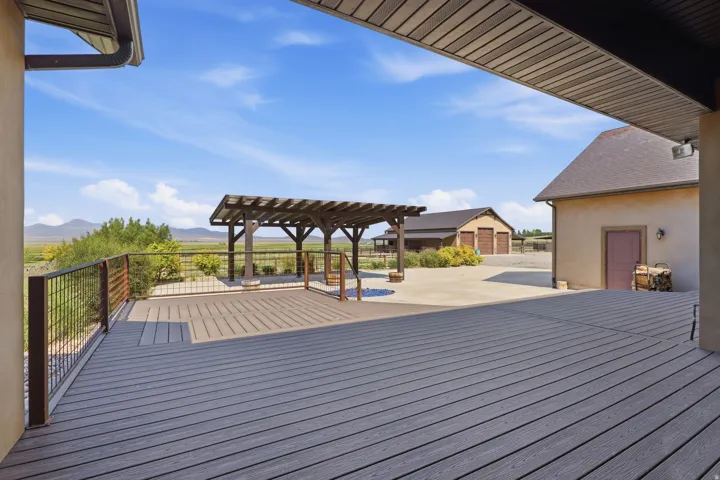 Spacious outdoor deck featuring composite decking and a sturdy metal railing