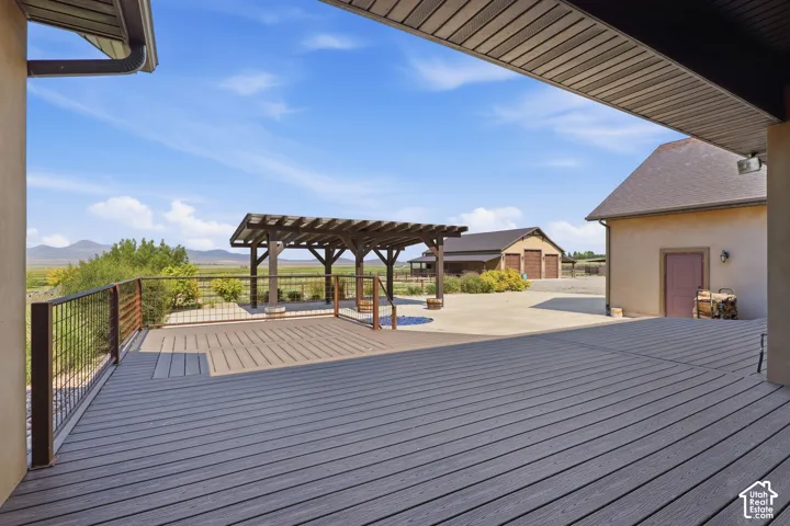 Spacious outdoor deck featuring composite decking and a sturdy metal railing
