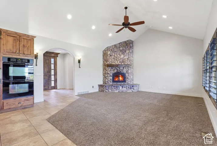 Vaulted ceilings with recessed lighting and a ceiling fan