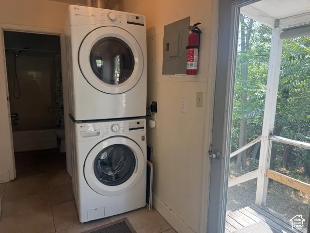 Stacked washer and dryer units by rear door on main floor
