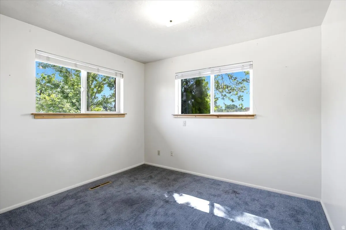 Neutral white walls with two windows featuring wood window sills