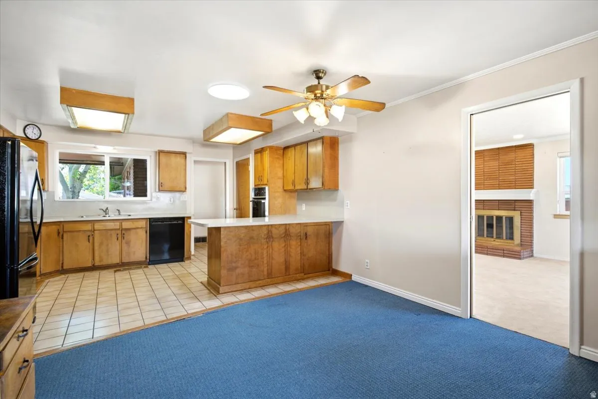 Eat-in kitchen featuring wood cabinetry, tile flooring, and a breakfast bar