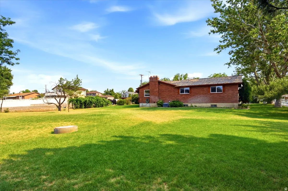 Expansive green lawn with mature trees and a concrete ring