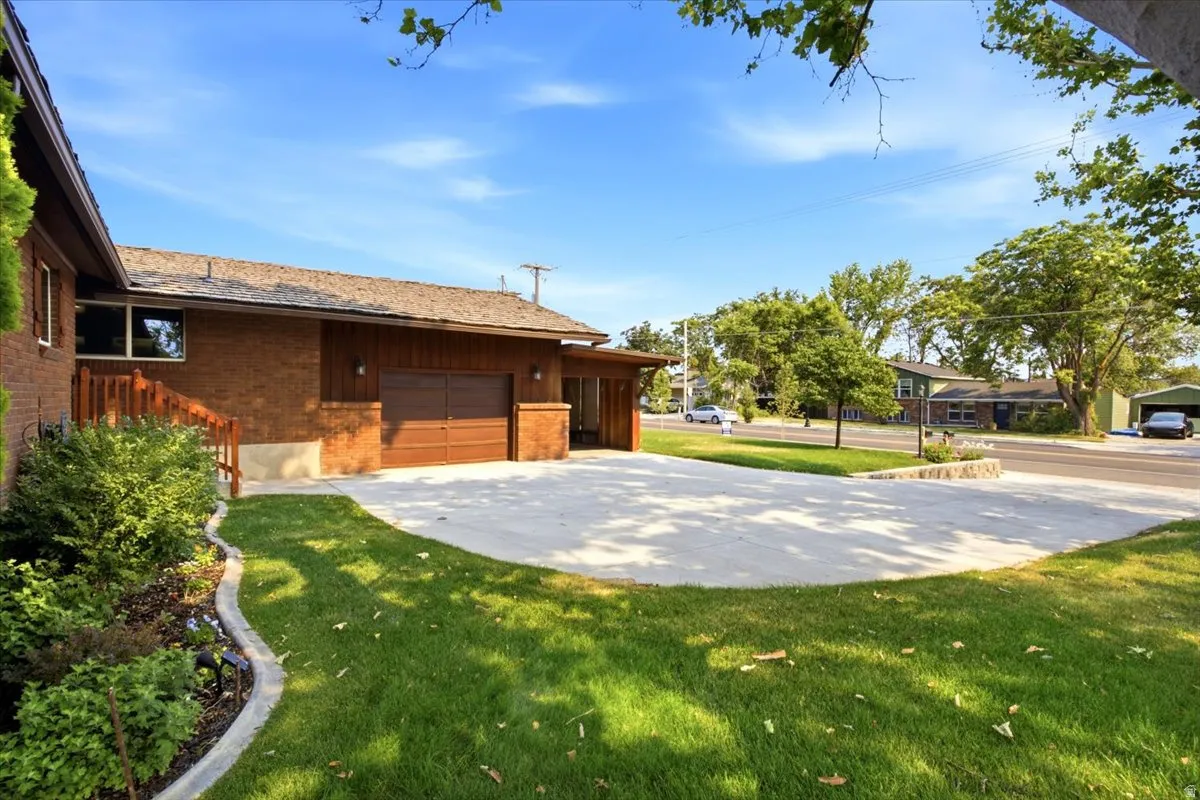 Brick exterior with wood siding accents and a cedar shake roof