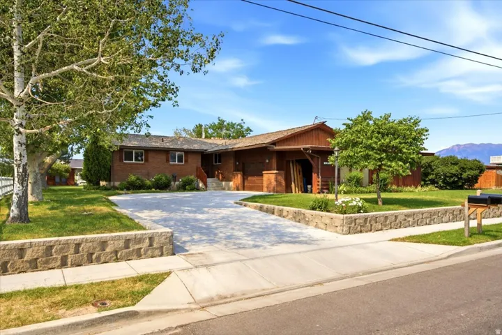 Brick and wood-sided residence featuring a multi-level design and an attached carport