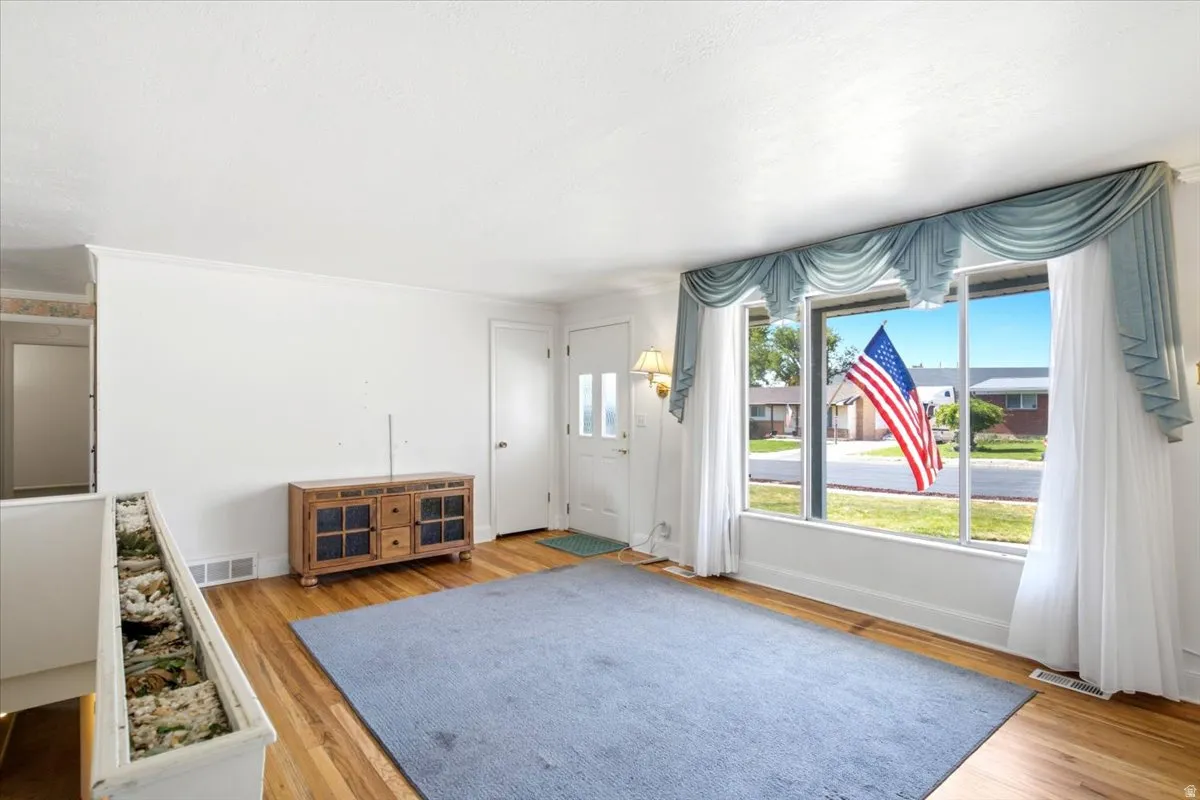 Big bright picture window, wood-finish flooring, white walls, a closet and of course, the front door.
