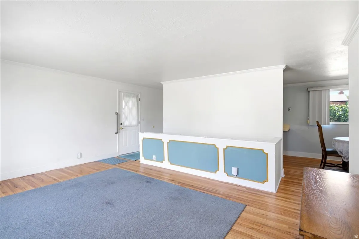 See the short wall with the blue rectangles? That is a privacy wall for the stairs going down to the basement. The back door is to the left of it.