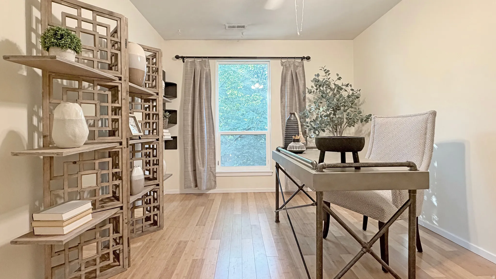 Light wood-finish flooring complements neutral wall tones. Second bedroom upstairs.