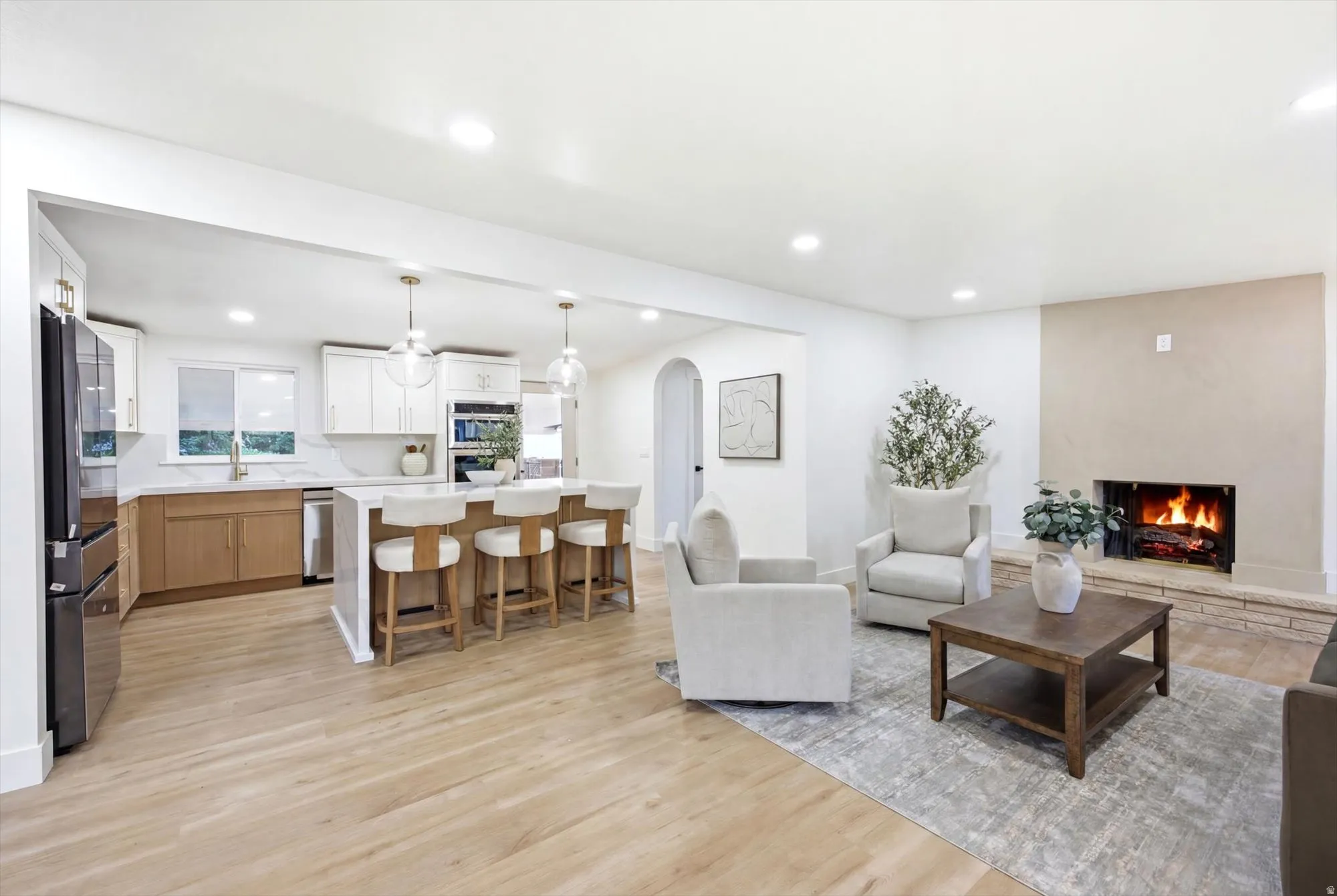 Open-concept living space featuring wood-finish flooring throughout