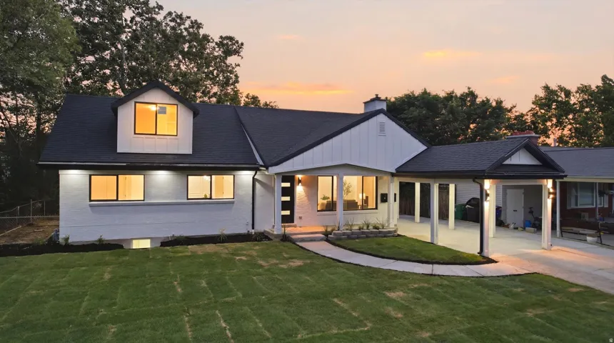 Modern exterior with a contrasting dark roof and white siding