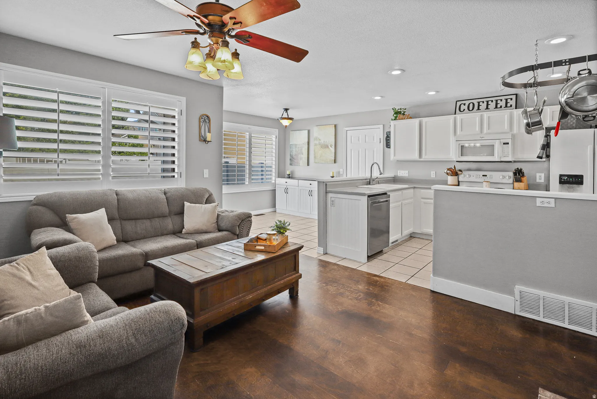 Open concept living area featuring dark wood-finish flooring