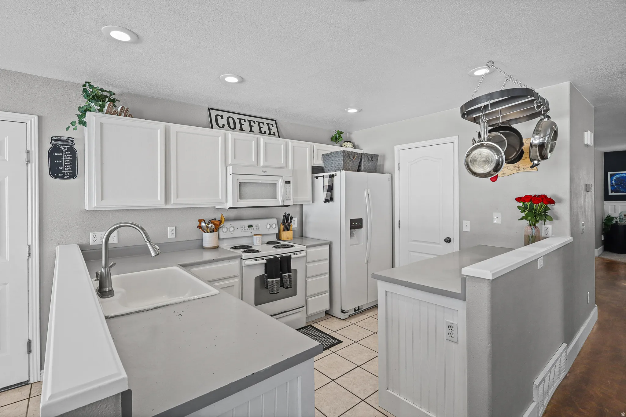Kitchen featuring white cabinetry, light gray countertops, recessed lighting, and tile flooring