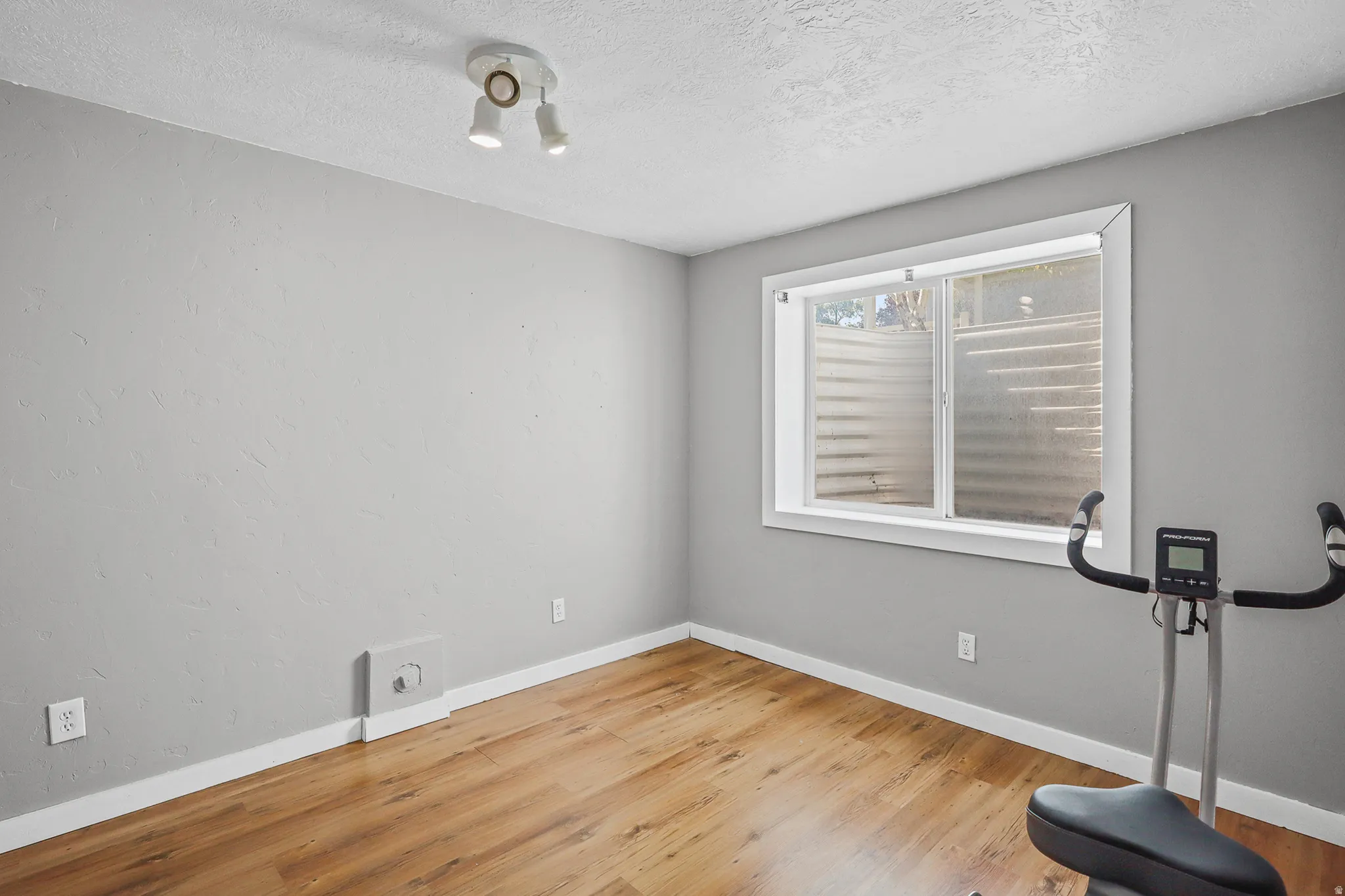 Neutral gray walls complement the wood-finish flooring