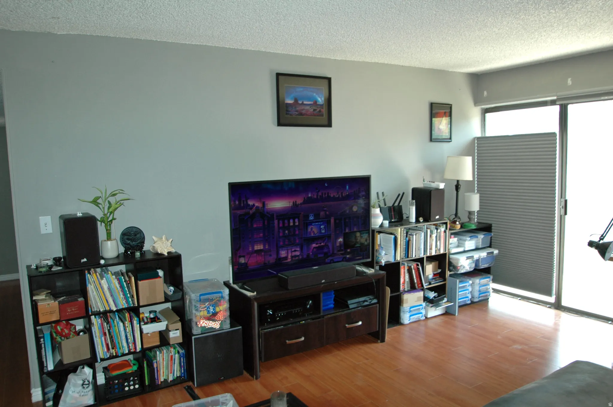 Light gray walls complement the wood-finish flooring in this living area