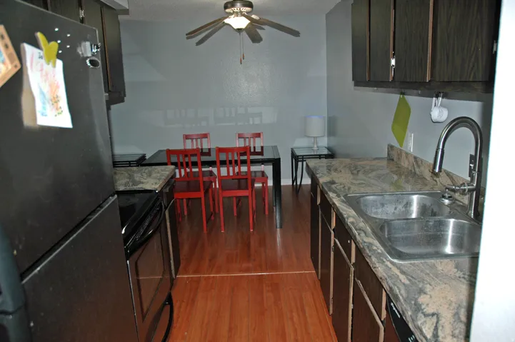 Kitchen and dining area featuring wood-finish flooring
