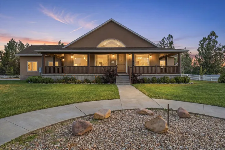 Stucco exterior with a covered porch and railing