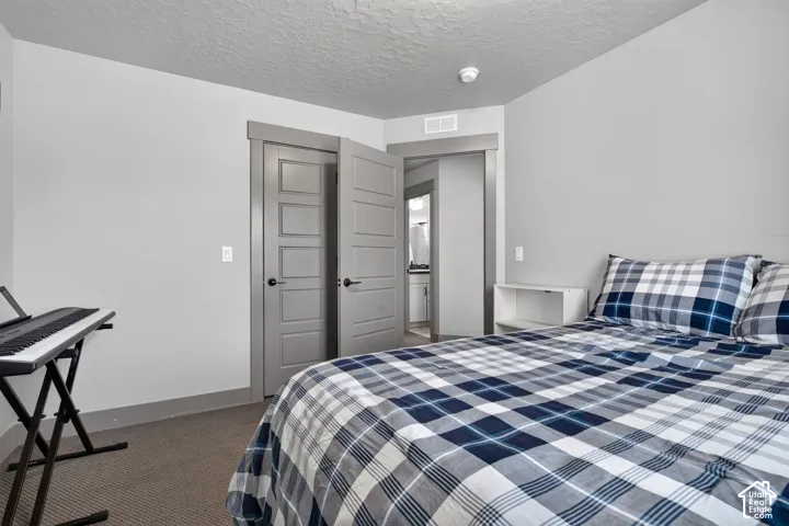 Carpeted flooring, light grey wall paint, and grey trim