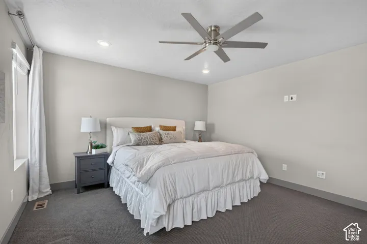 Recessed lighting, wall-to-wall carpeting, and a modern ceiling fan with brushed nickel accents