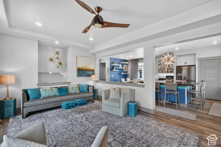 Open concept living area featuring recessed lighting, a ceiling fan, and LVP flooring