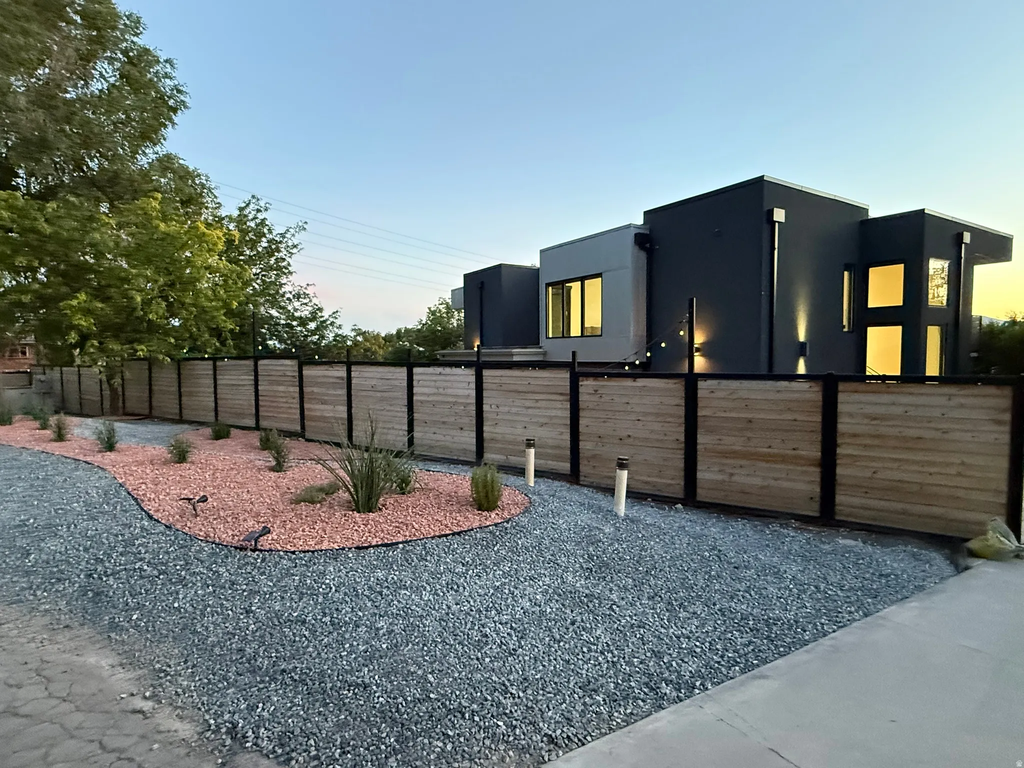 Modern exterior featuring a dark gray facade and multiple windows