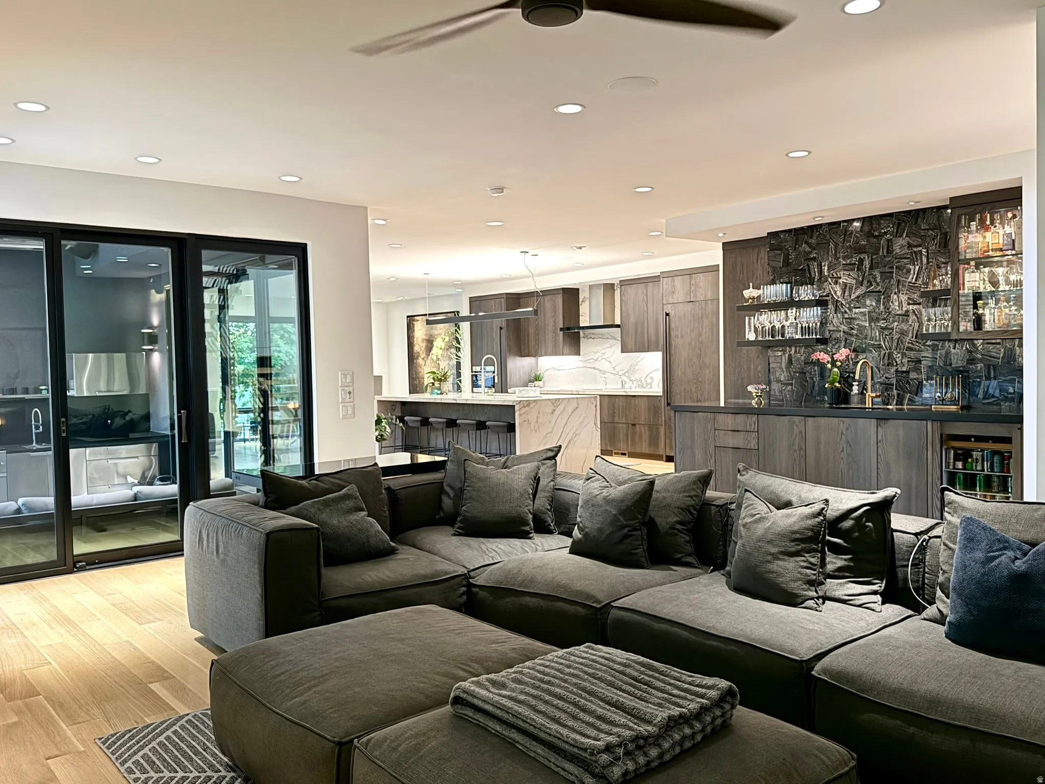 Open-concept living area with light wood-finish flooring