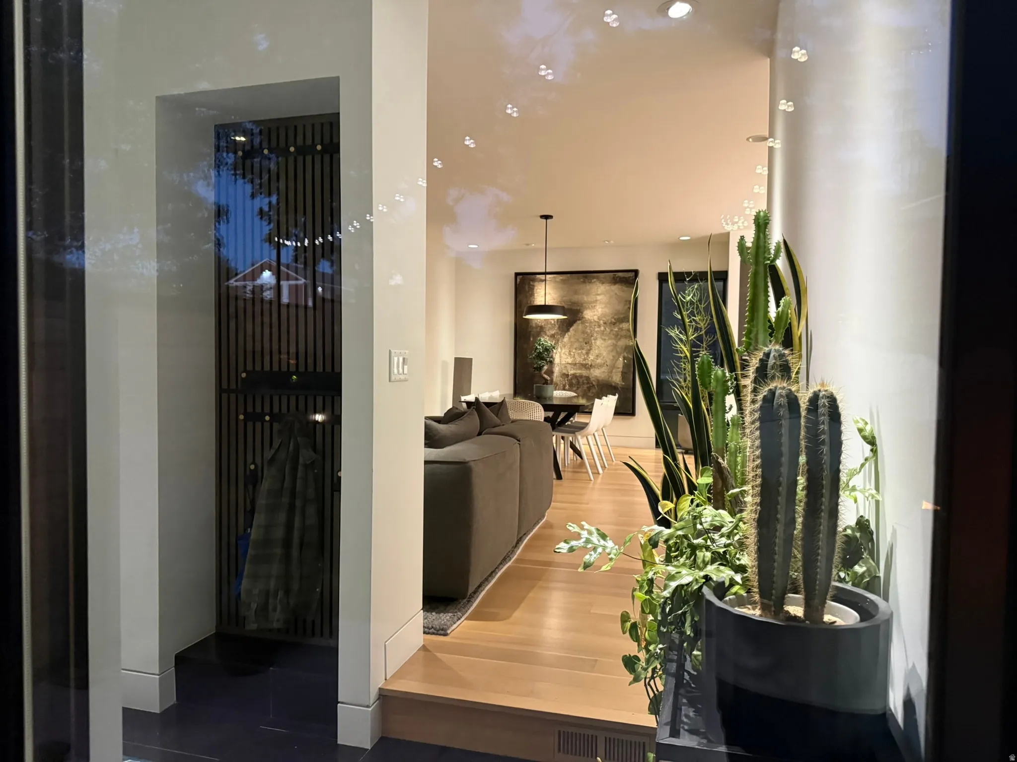 Hardwood flooring present in open-concept living area