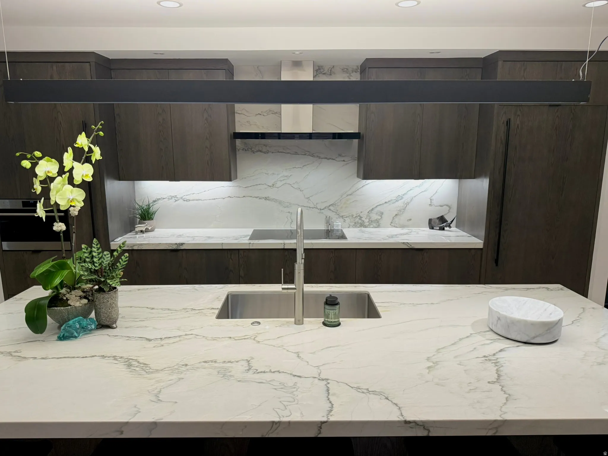 Kitchen featuring a spacious island with an undermount sink and contemporary faucet
