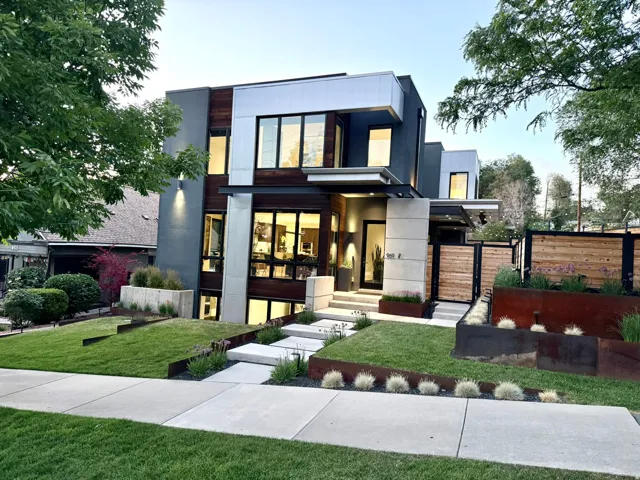 Modern architectural exterior featuring multiple material finishes including wood-finish siding and stucco