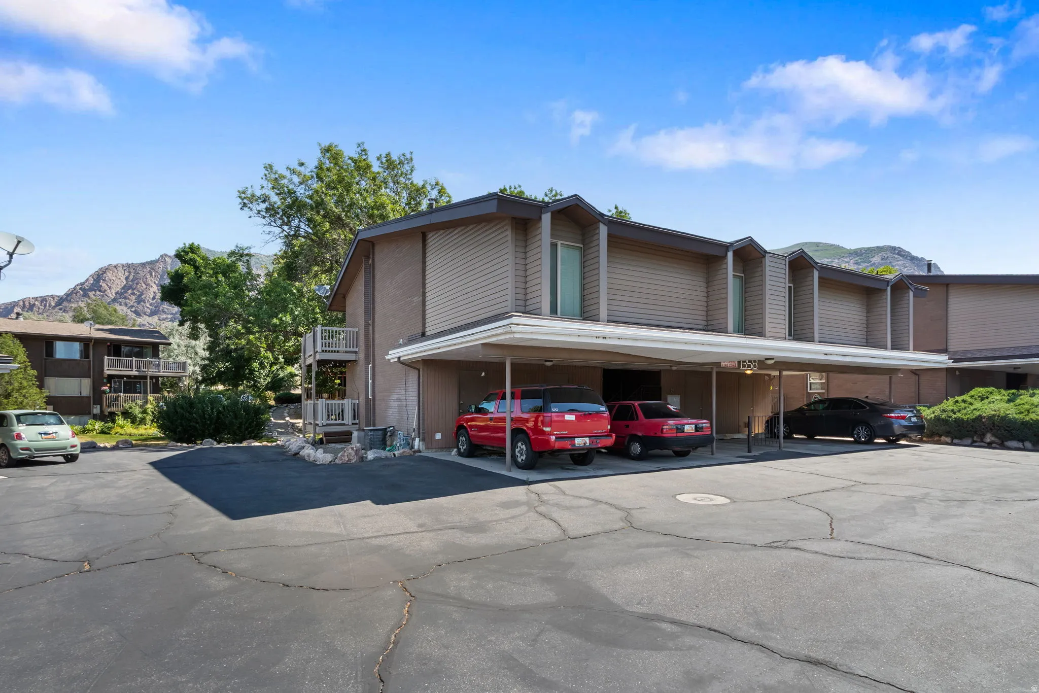 Multi-unit building featuring a stucco and horizontal siding exterior with a flat roofline