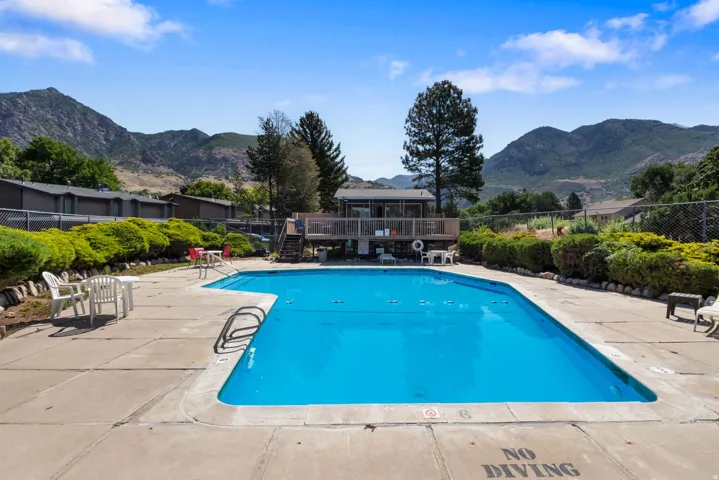 Outdoor swimming pool featuring a concrete deck and surrounding landscaping
