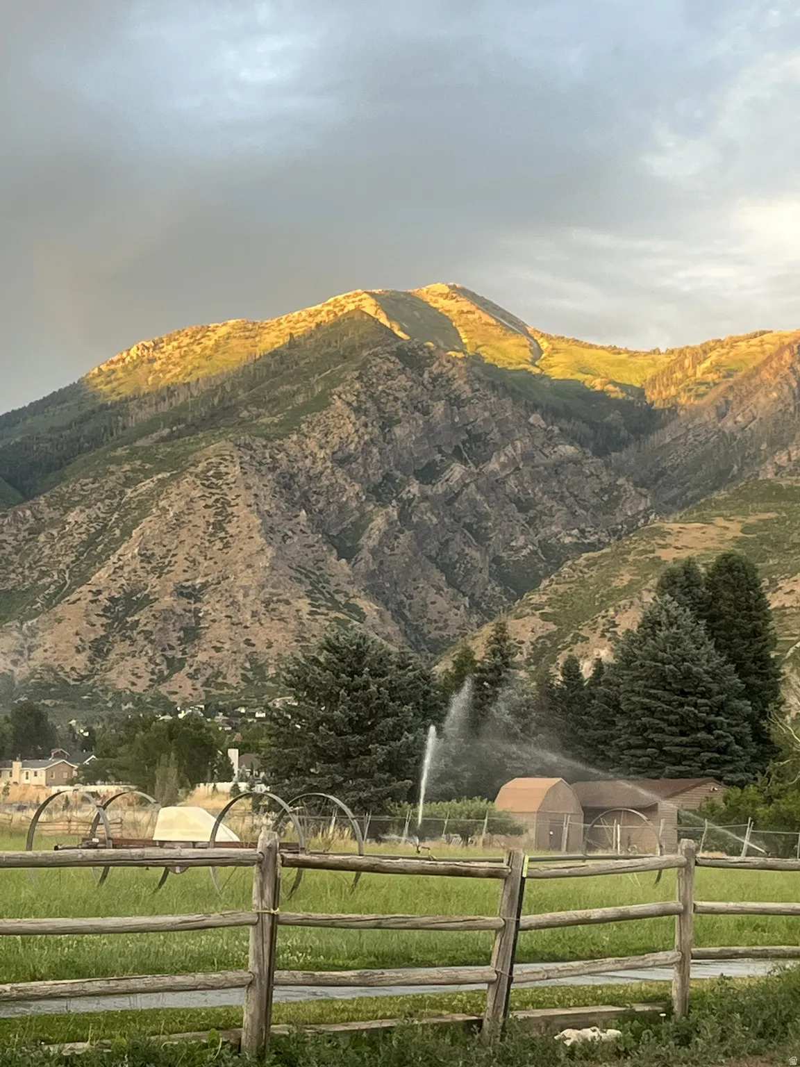 Expansive mountain backdrop featuring prominent rocky peaks and forested slopes