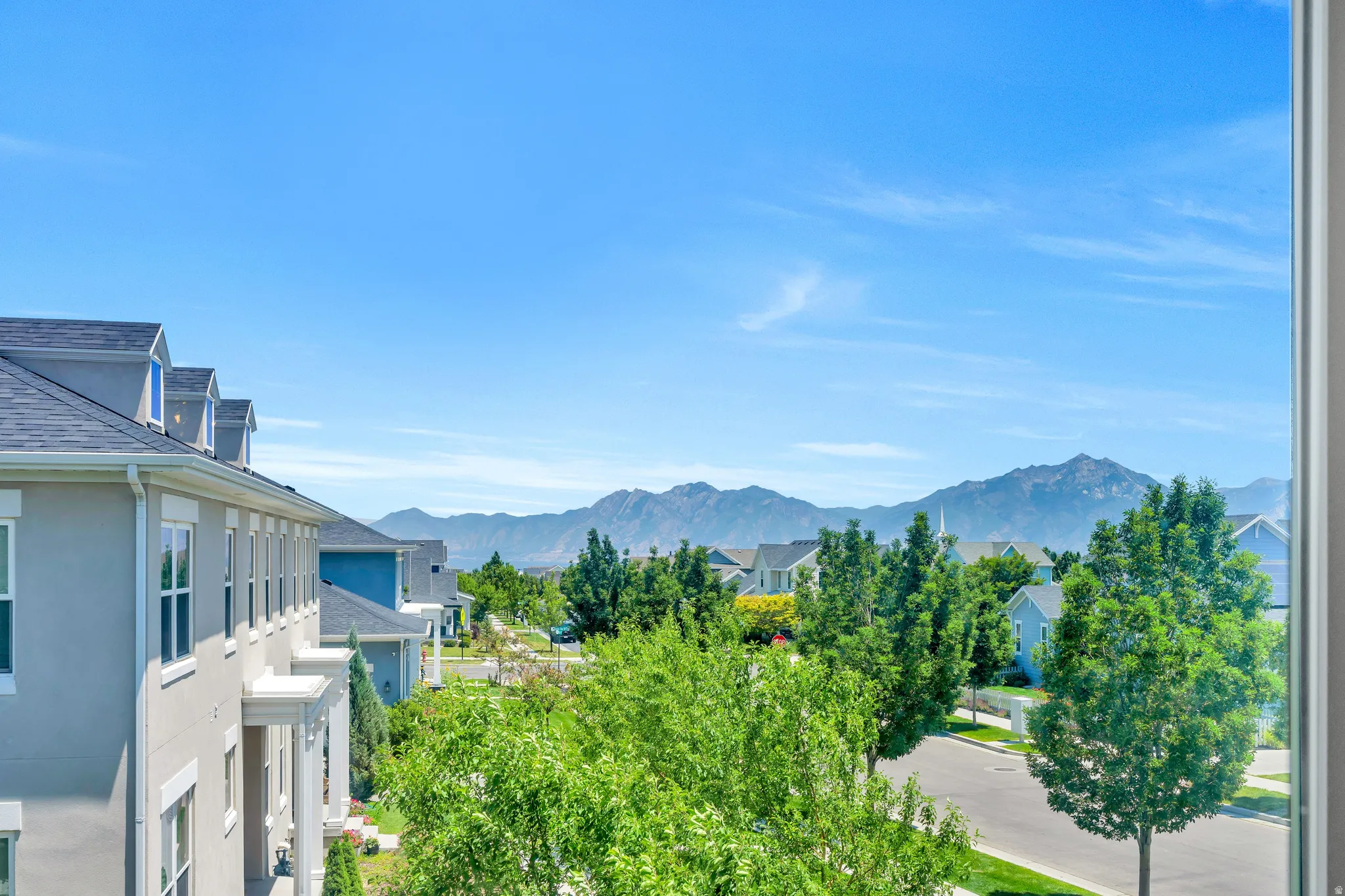 Sweeping mountain scenery from a window with a white frame