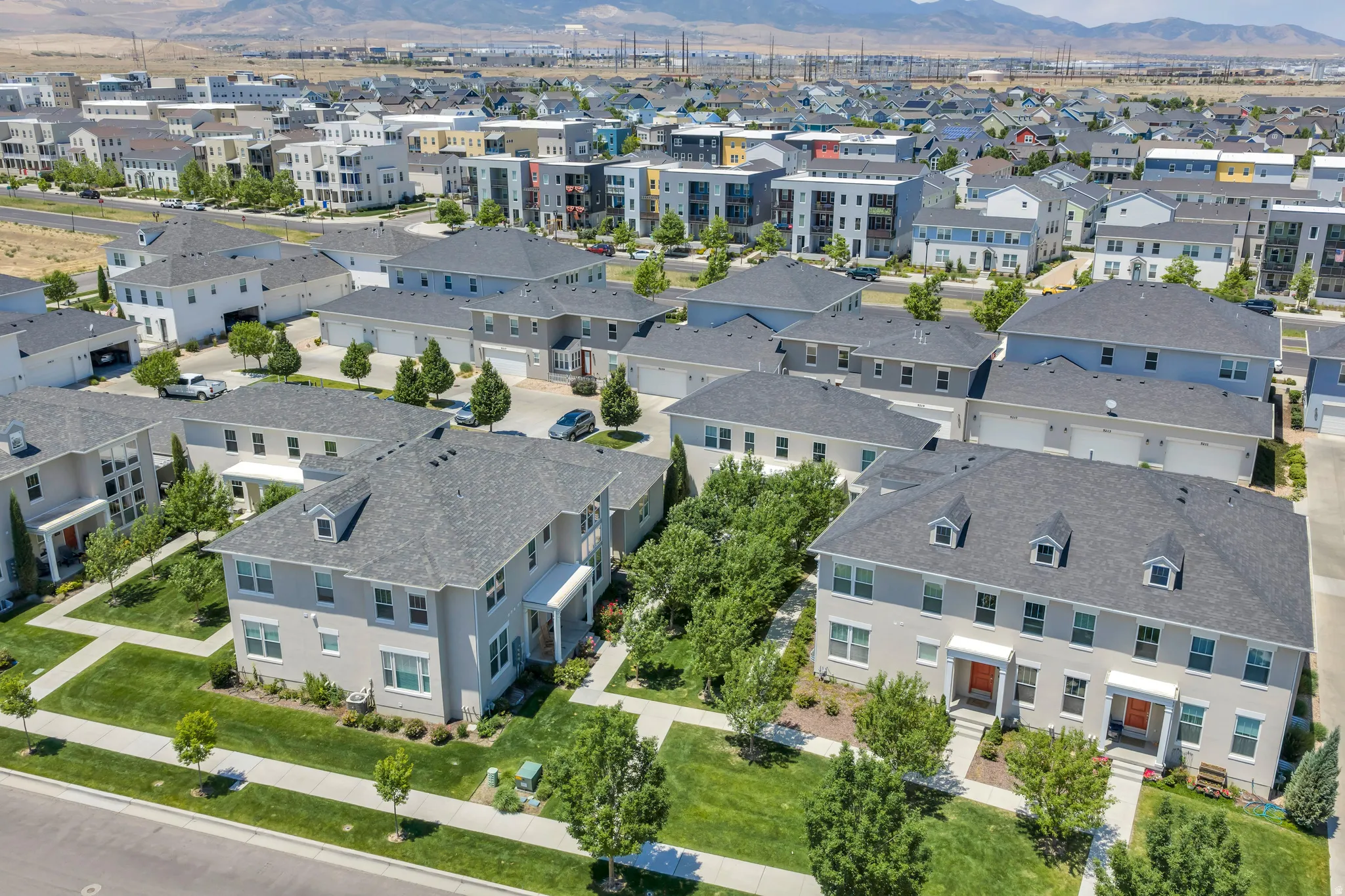 Aerial perspective of a contemporary residential development featuring multiple detached and attached structures